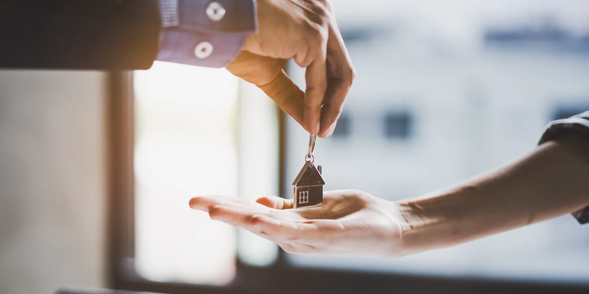 close-up-view-hand-property-realtor-landlord-giving-key-house-buyer-tenant