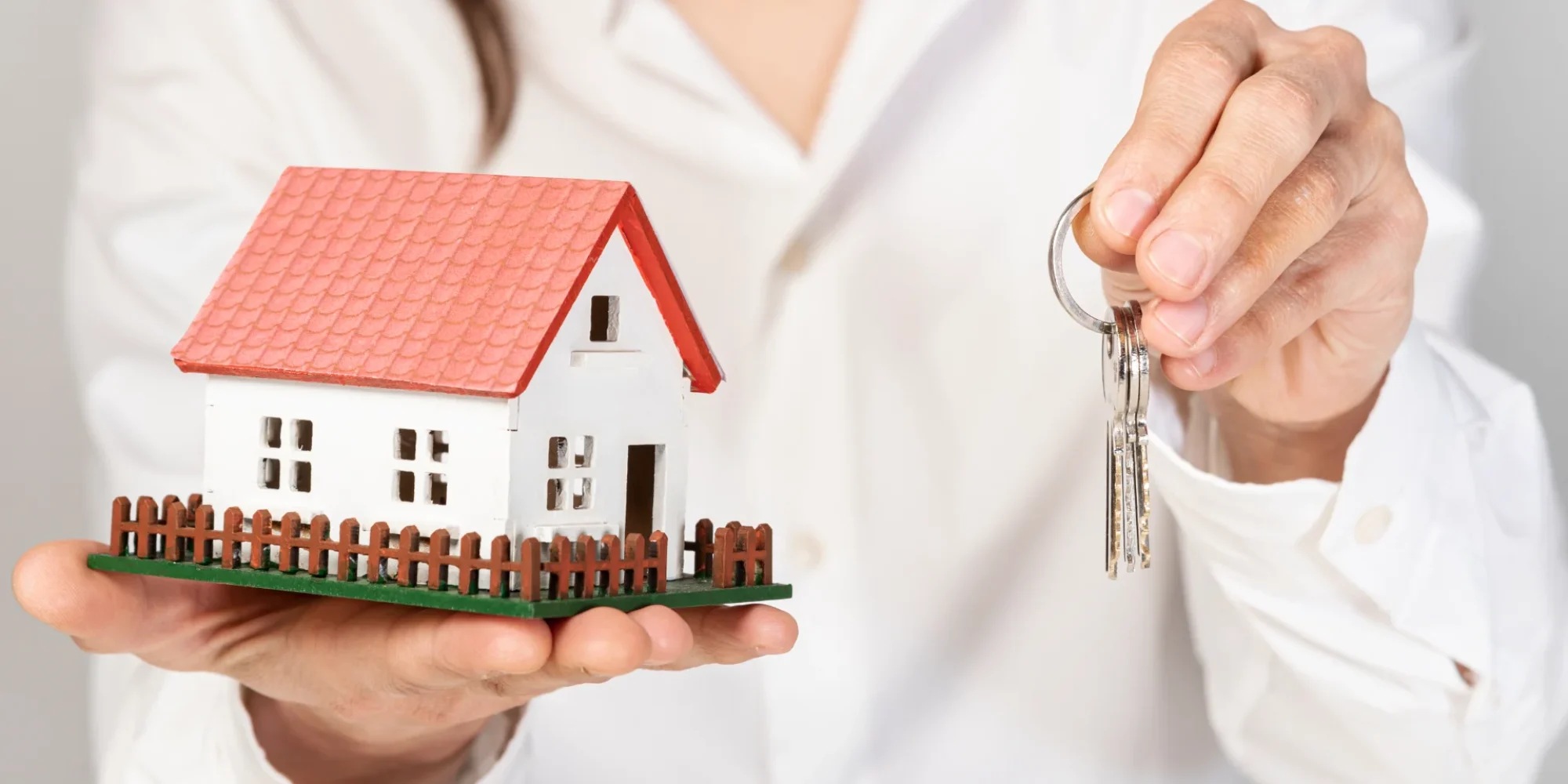 female-holding-toy-model-house-keys